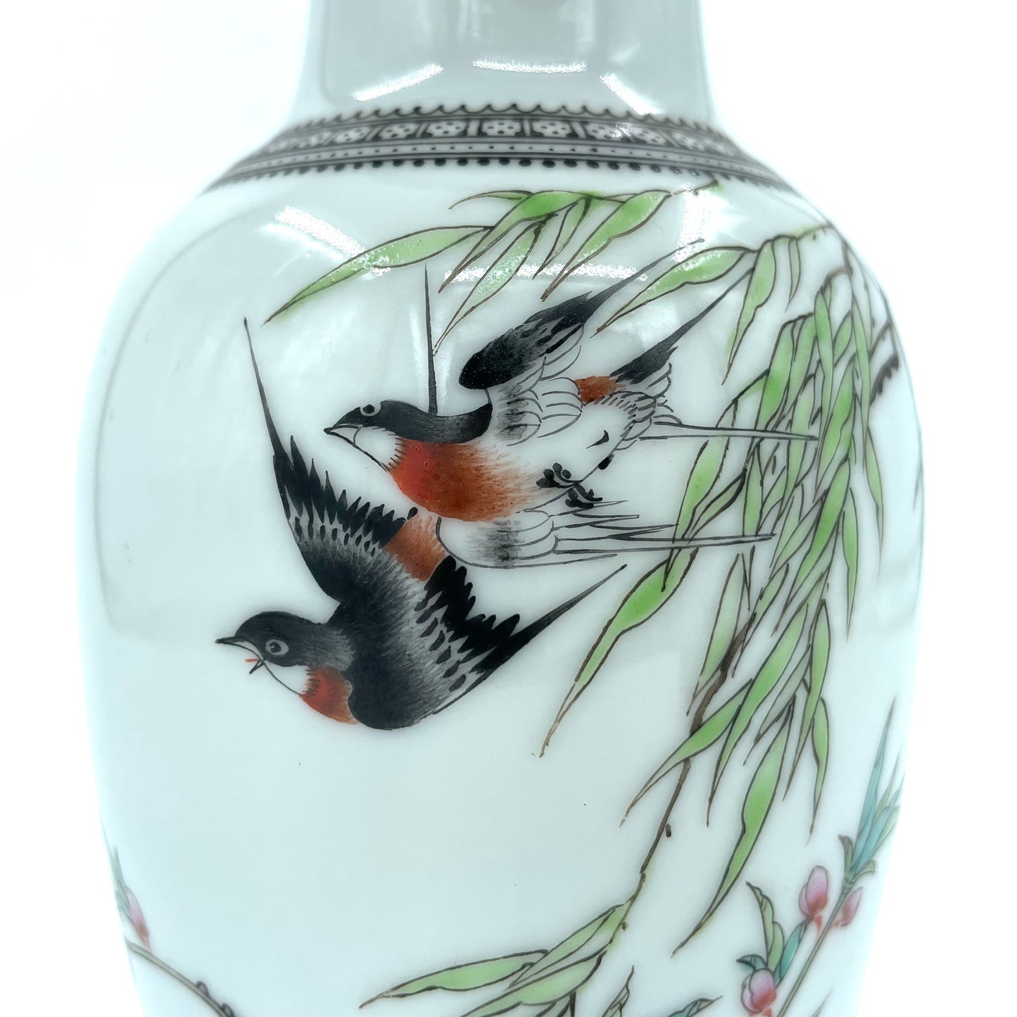 Close-up on the birds and flowers on this vintage Chinese famille rose vase
